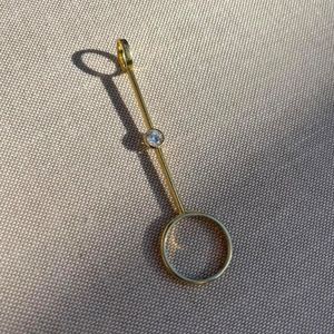 Gold plated with clear stone cigarette holder/joint holder ring.